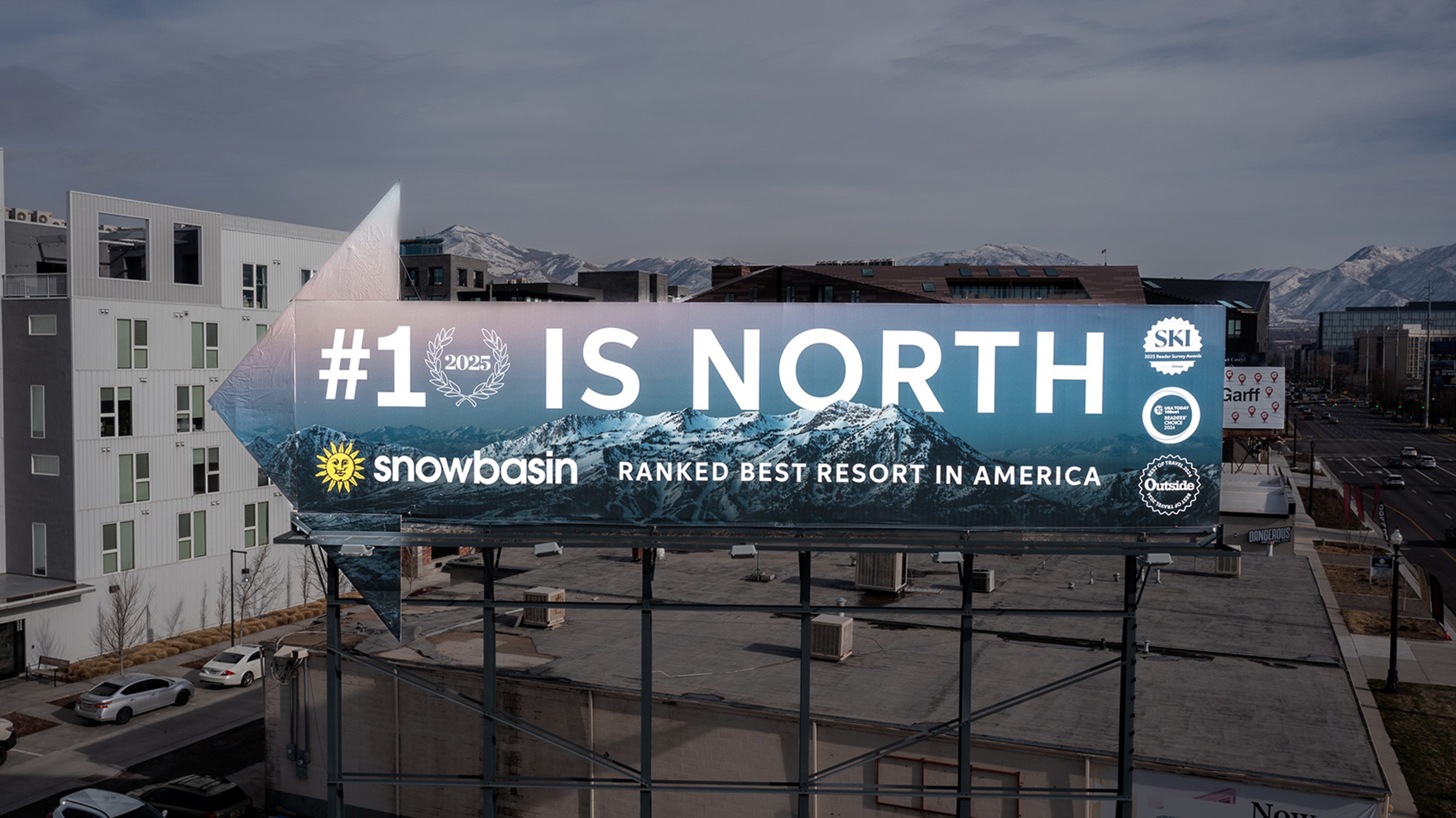 A Snowbasin Resort billboard celebrating No. 1 rankings from USA Today, SKI Magazine, and Outside