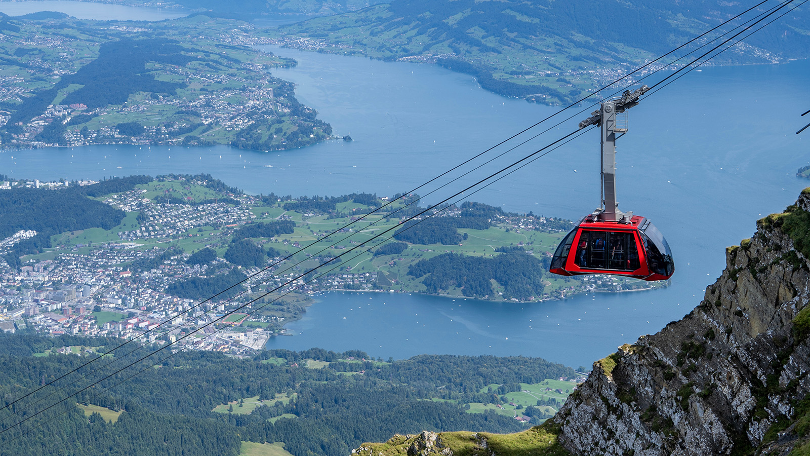An aerial tram ascends Mount Pilatus above Lucerne, Switzerland. Lift-served experiences are the assets a resort owns, and they are where resorts hold up best in AI summer answers. Mountain biking questions surfaced a resort 89 percent of the time, and mountain adrenaline activities like coasters and zip lines 67 percent.